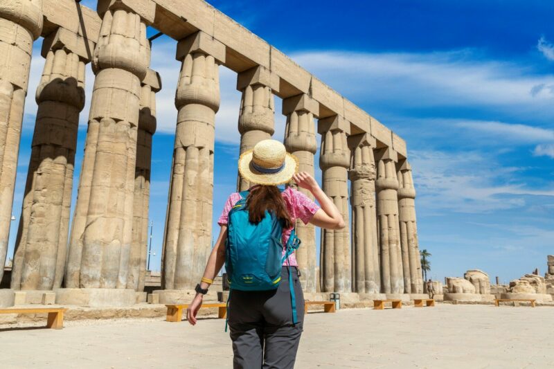 Woman tourist at Luxor Temple in a sunny day, Luxor, Egypt.